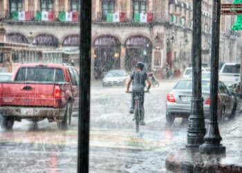person riding a bicycle during rainy day