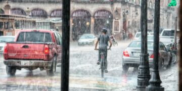 person riding a bicycle during rainy day