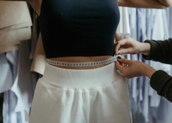 photo of person measuring woman s waist