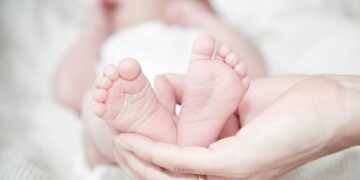 close up of hands holding baby feet