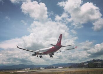 photo of airplane over runway