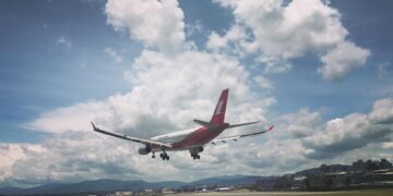 photo of airplane over runway