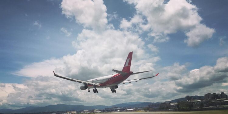 photo of airplane over runway