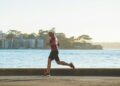 man running near sea during daytime