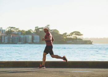 man running near sea during daytime