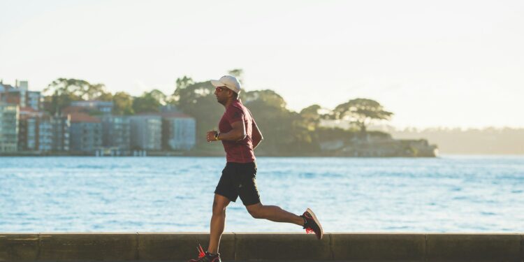 man running near sea during daytime